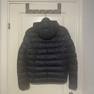 Colmar jacka  - Marinblå Colmar jacka i storlek 44 som motsvarar S. Har tecken på användning.  Dragkedjan på ena fickan går ej att stänga, går att laga hos skräddare.