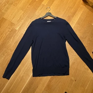 Mörkblå crewneck - Säljer en stilren mörkblå tröja i bra skick. Den har en enkel design och är perfekt för både vardag och lite finare tillfällen. Passar bra till jeans. Storlek XS men passar även S. Säljer till riktigt bra pris.