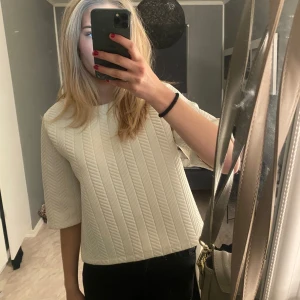 Vit ribbad tröja - Säljer en stilren vit ribbad tröja med trekvartsärm. Perfekt för både vardag och lite finare tillfällen. Tröjan har en skön passform och är lätt att matcha med olika outfits. Passar bra till både jeans och kjol!