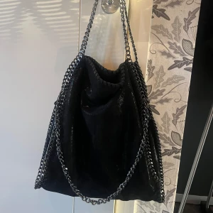 Svart glittrig axelväska med kedjor - Snygg svart axelväska med kedjeband. Använd få gånger😇perfekt till skolan😍