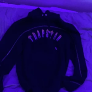 Trapstar X Central Cee tracksuit hoodie (yellow font) - (Central Cee X Trapstar släpp) Säljer en svart hoodie från Trapstar i mycket bra skick. Den har en stor logga på framsidan och är perfekt för höst och vinter. Hoodien har långa ärmar och en klassisk passform med luva. Bara att höra av er om några frågor kommer upp!