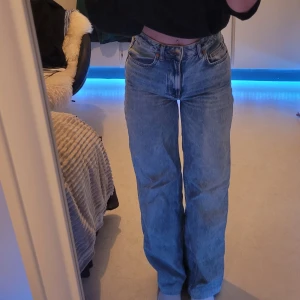 Blå jeans från Bik Bok - Säljer ett par snygga blå jeans från Bik Bok i modellen Tower Wide. De är högmidjade och har en avslappnad, wide fit. Perfekta för både vardag och fest! Materialet är 100% bomull vilket gör dem bekväma och hållbara. Använda men i mycket bra skick. Passa på att fynda dessa stiliga jeans! Jeansen är uppsydda men inte avklippta så det går att sprätta upp om man vill ha den längd som står i storleken.