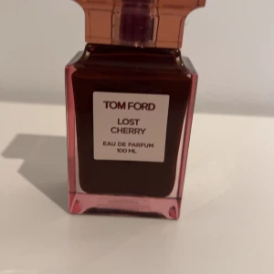 Tom Ford Lost Cherry Eau de Parfum - Säljer en lyxig flaska Tom Ford Lost Cherry Eau de Parfum, 100 ml. Flaskan är elegant med en djup röd färg och en stilren design. Perfekt för den som älskar en söt och fruktig doft med en touch av körsbär. Passar både till vardags och fest! OANDVÄND