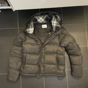 Svart pufferjacka från Burberry - Hej! Säljer en fet jacka från Burberry. Jackan är i nyskick och svart färg. Storlek är M. Skriv gärna privat för fler bilder! 🥂