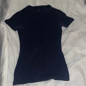 Marinblå t-shirt från Intimissimi - Säljer en stilren marinblå t-shirt från Intimissimi i Supima bomull. Den har en klassisk rund hals och korta ärmar, perfekt för en enkel och bekväm look.