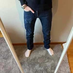 Mörkblå jeans från Tiger of Sweden  - Snygga mörkblå jeans med en klassisk straight passform. Perfekta för en avslappnad stil. De har en midwaist och är tillverkade i ett robust denimtyg.