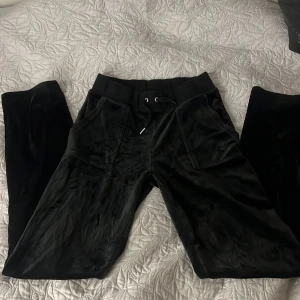 Svarta mjukisbyxor från Juicy Couture - Snygga svarta mjukisbyxor från Juicy Couture. Köptes från Thernlunds och helt oanvända. Perfekta för en avslappnad stil med en touch av lyx. 💞
