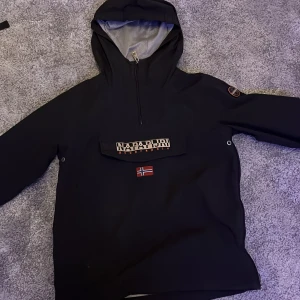 Vindjacka napapirji nypris 1800 - Riktigt fet vindjacka från napapapirji. Storlek är 14 år /164 cm. Snygg svart nyans. Nypriset av denna jacka var 1800 kr.