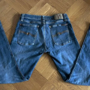 Nudie Jeans - Vi säljer nu ett par blå Nudie Jeans i storlek W32 L32! Jeansen är i passform slim och är typ helt nya. Pris kan diskuteras vid snabb affär! 