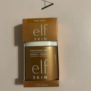 Bronzing Drops från e.l.f. Skin - Bronzing Drops i nyansen Pure Gold från e.l.f. Skin. Innehåller antioxidanter och solrosfröolja för att ge en solkysst look samtidigt som huden vårdas. Perfekt för att addera en gyllene glöd till din hudvårdsrutin.
