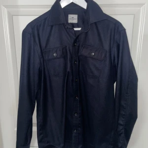 John henric overshirt - En marinblå John henric overshirt i ull, bra skick. Perfekt nu inför vår o sommar. Tveka inte på att höra av er för fler bilder eller frågor! 