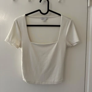 Vit topp från Amisu - Säljer en stilren vit ribbad topp från Amisu med korta ärmar och fyrkantig halsringning. Storlek M🤍