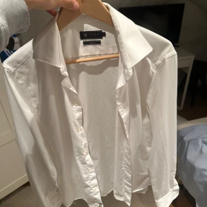 Vit skjorta från Riley - Snygg vit skjorta från Riley i storlek S. Skjortan har en klassisk design med knappar framtill och en stilren krage. Perfekt för en stilren look.