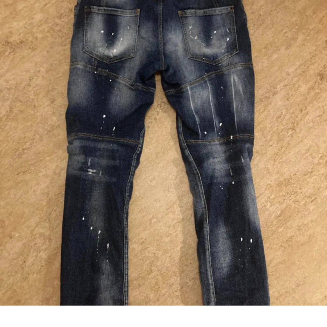 Mörkblå jeans med slitningar och färgstänk - 1
