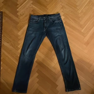 Blå jeans från Replay - Snygga blå jeans från Replay med en klassisk femficksdesign. De har en dragkedja och knapp framtill. Perfekta för en stilren look.
