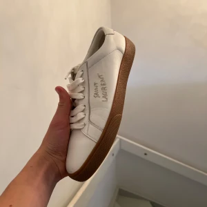 Saint laurent sneakers  - Hej säljer nu mina gamla saint laurent sneakers, de ör i extremt bra skick slm ni ser på bilderna, de är i storlek 39 men passar 40, har du några frågor eller funderingar hör av dig, OBS boxen på bilden ingår ej 