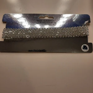 Glittrigt halsband från Red Carpet Collection - Snyggt och glittrigt halsband från Red Carpet Collection. Halsbandet är i silver och ganska kort. Aldrig använt, nypris 198 kr.