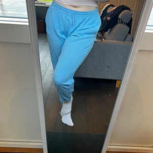 Blå mjukisbyxor från H&M - Säljer ett par superbekväma ljusblå mjukisbyxor från H&M i storlek M. Byxorna har elastisk midja med snörning. De har också praktiska sidofickor. Använd några få gånger🩵