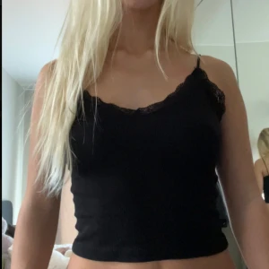 Svart linne med spetsdetaljer - Säljer ett gulligt linne från stradivarius💕