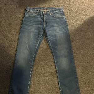 Ett par helt nya Nudie Jeans i modell Grim Tim med färg Shadow Blues. Storlek 34/36. Passformen är bara lite pömsigare än ett par slim jeans men absolut inte baggy. Priset kan gå ner snabbt vid snabb affär. Retail: 1600