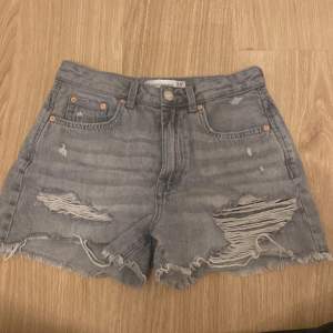 Säljer ett par grå jeansshorts från Stradivarius i storlek 36. De är i vintage-stil med slitna detaljer och fransiga kanter. Perfekta för en avslappnad sommarlook! köpta i Spanien. pris kan som vanligt diskuteras❤️