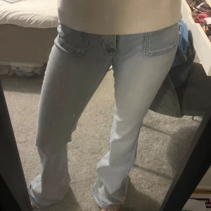 Ljusblå bootcut jeans - Snygga ljusblå bootcut jeans med låg midja. Perfekta för en avslappnad stil. Klassisk femficksdesign och dragkedja med knapp framtill. Jättepopulära