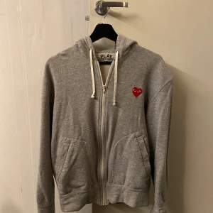 Hej, jag säljer en stilren cdg zip Hoodie. Hoodies skick är 8/10 då den är sparsamt använd samt utan fläckar. Säljer då den inte passar mig längre. Vid frågor och funderingar är det bara att höra av sig. Pris kan diskuteras! 