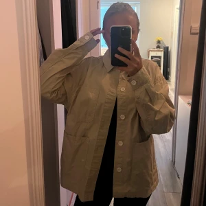 Tunn jacka  - En tunn beige jacka ifrån Pull and Bear. Jackan har tre fickor på framsida och har även vita knappar så man kan stänga jackan. Jackan är aldrig använd och är därmed i nyskick!🙌🏼(Skriv för fler bilder) 