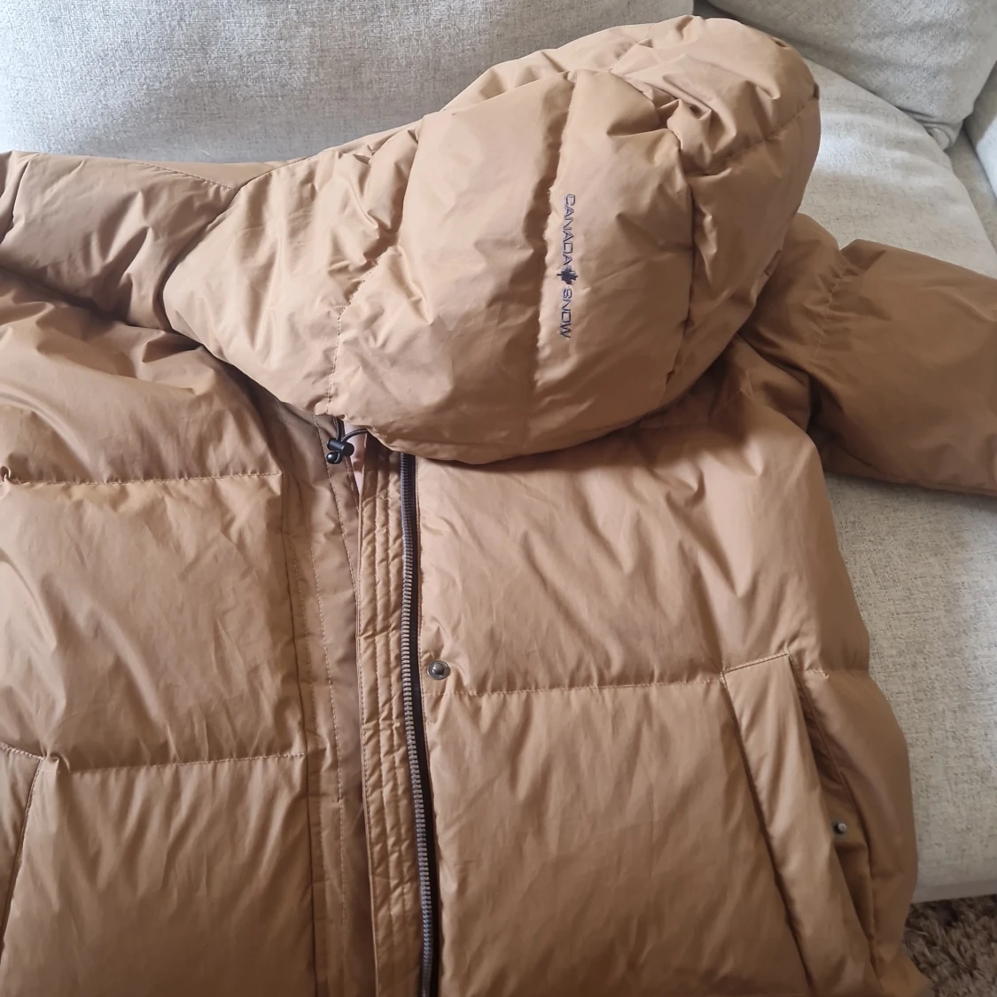 Brun lång dunjacka från Canada Snow - 91