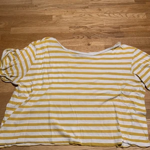Yellow & white striped t-shirt - This striped t-shirt is very flexible and comfy. It’s a little short around the waist, but it’s very beautiful.