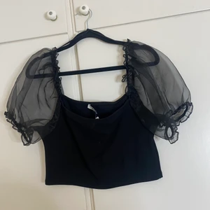 Top från NA-KD  - Fin top från NA-KD med transparenta ärmar strl L men passar medium också 