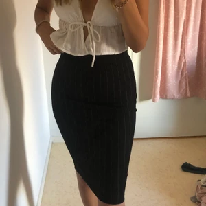 Kjol - Svart kjol med vita sträck som på mig som är 174 cm lång slutar vid knäna. Storlek XS men stretchig. Säljes då den inte kommer till användning. Köparen står för frakt. 