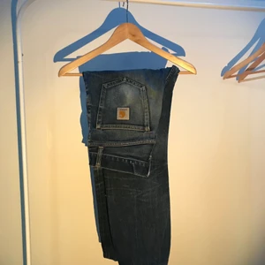 Carhartt Jeans - Blå jeans från Carhartt W.I.P i storlek 30/32. Gamla favoritjeans, alltså väldigt använda. Modellen är straight. Uppvikna/uppsydda. Inga hål eller slitage på materialet. Nypris är 1000kr.