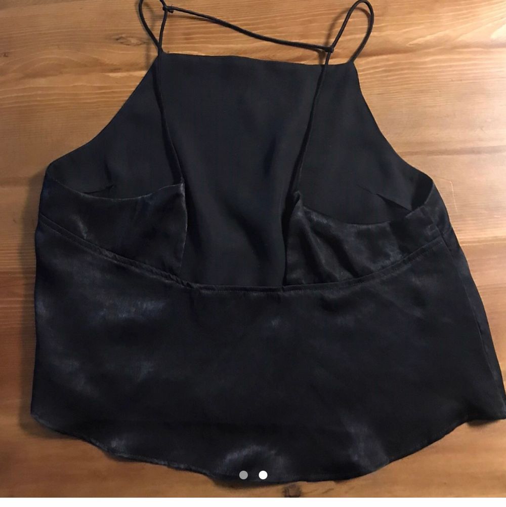 Black slinky silk fabric with strappy detail on back. Darted bust. Kinda like an A-line babydoll hem?! The hem is floating. Not stretchy. Silk blend. Fully lined. Fits XS/S best (I am 5'4 and 98 for reference). Mildly used excellent used condition. No fading, holes, tears, rips, stains, snags. Smoke and pet free storage space. No other flaws to note. Since this is true vintage, I cannot speak for how the previous owner took care of this garment, but there are no egregious flaws to note. I will hand wash and steam prior to posting. Happy to bundle. Will gladly take more pics. Disclaimer: Please expect some general wear in all secondhand pre-owned items as they have lived a previous life, so do not expect a mint item.. Toppar.