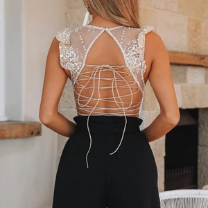 Festlig body med öppen rygg strl XS - ”Sparkly” body med öppen rygg och snörning. Endast testad. Så himla fin, säljes då den dessvärre inte kommit till användning. Perfekt till nyår! Nypris US$67.00 från HelloMolly. 