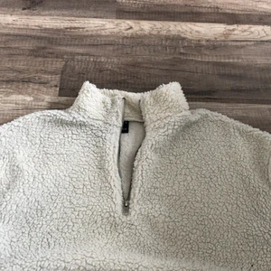 En vit lurvig tröja från gina tricot. - Den är lite disig ute vid armen men det är inget som syns. Den är jätte mysig och varm och har en kort dragkedja upp till halsen. 75kr + frakt.