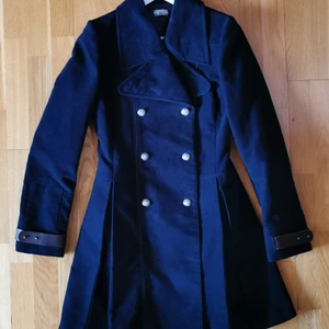 Hunkydory Kappa i storlek S.  - Märke: Hunkydory Typ: Kappa Storlek: S Färg: Marinblå Material: 100% bomull. Lining: 95% acetat, 5% elastan. Spännen i ärmslut 100% äkta läder.  Kroppstyp: Kvinna  Kvinnlig och elegant kappa. Endast använd vid fåtal tillfällen. Inga defekter eller slitage. I princip nyskick.  Betalning sker via swish innan leverans. 