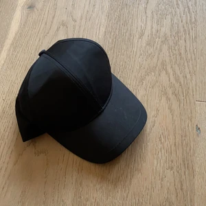 Keps från Filippa K - Svart keps från Filippa K! Knappt använd. Köpare står för frakt! Spänne baktill där en kan ändra storlek 
