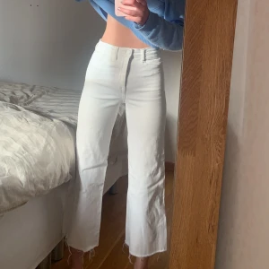 Vita jeans - Säljer dessa jeans som sitter som en smäck på kroppen. De är vida nedtill och lite kortare, skitsnyggt till birkenstock på sommaren. De är från HM och nypris var ca 300kr! De är strl 34 men bra stretch så passar även mig som är 36!