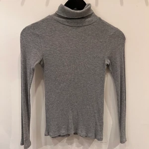 Grå polotröja från Topshop - Grå polotröja från topshop i skönt tyg. Storlek 38 men fungerar på 32-38 då tyget är tajt men stretchigt. Jag är själv vanligtvis en 34-36. 