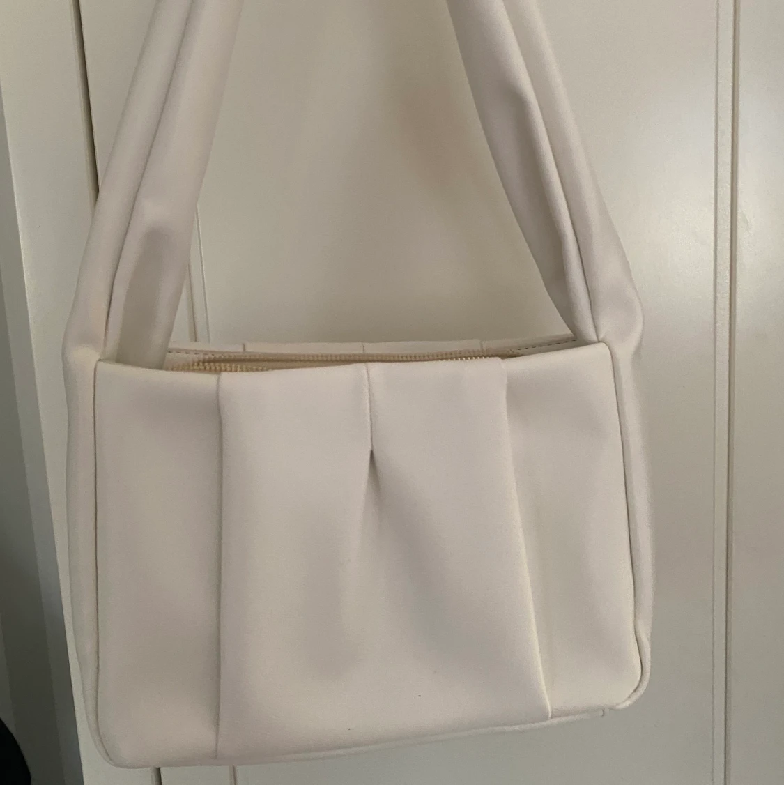 Vit axelremsväska