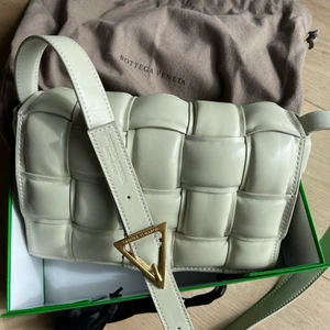 Bottega Veneta väska + box och påse - Intressekoll på min Bottega väska som är fejk men är otroligt bra gjord. Väskan ska va i skinn och känns som skinn. Bra detaljer . Tillkommer box och dustbag. Skulle säga att färgen är som på tredje bilden och mer creme vit än åt de gula hållet som första bilden visar. Kan skicka mer bilder om så önskas. Skickar med spårbart efter betalning . Alltid 2 dagar ångerrätt. Då betalar du returen och jag måste ha spårbart så jag ser att du har lämnat in paketet . Väskan får ej säljas vidare som äkta! 