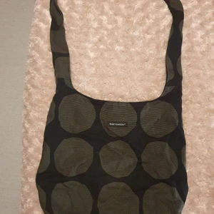 Marimekko tygväska - Svart/grå Marimekko tygväska. Innerficka med dragkedja. Bra skick. Ev frakt står köparen för.