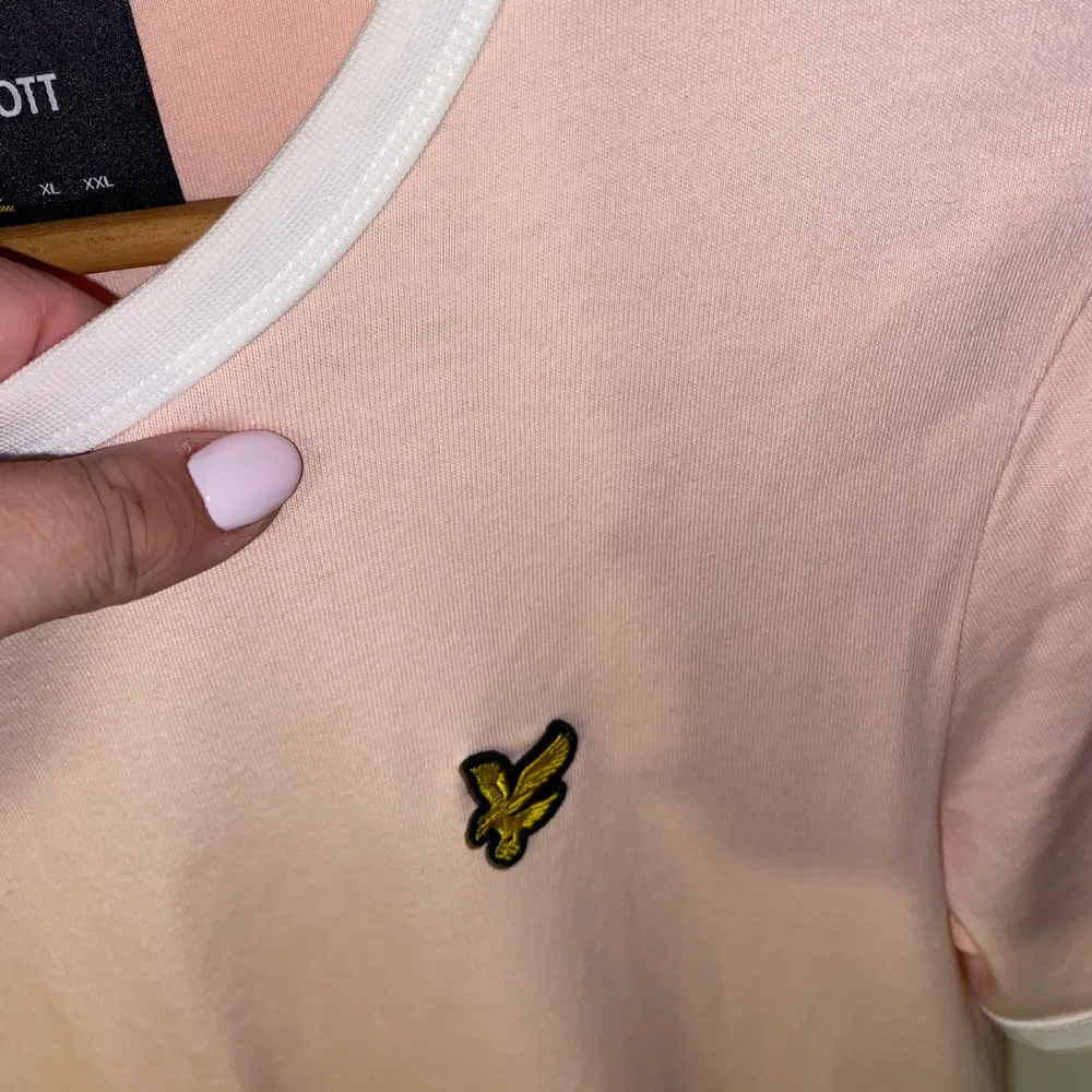 Superfin & OANVÄND t-shirt från Lyle and Scott. Bilderna missvisar färgen lite, den är väldigt fin ljusrosa, med de vita detaljerna & den gula Lyle and Scott märket. 💕 Tröjan är i strl L men passar M. Skicka privat vid intresse. Köparen står för frakten. . T-shirts.