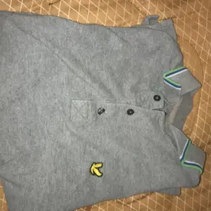 En grå och grön piké tröja 