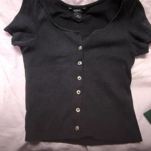 Svart t-shirt med knappar - Svart tröja med knappar i storlek xs, kommer inte till användning :(