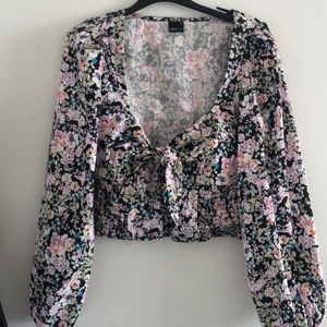 Crop top från Gina tricot storlek 36 - Slutsåld ljuvlig topp med lite puffade ärmar och knyt vid brösten. Passar storlek 36 och 38.