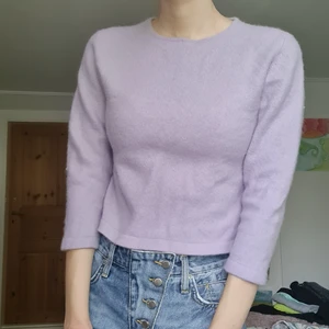 lila kashmir topp - Ljuslila tröja i storlek S men som krympt i tvätten. Lite croppad med trekvartsärmar. väldigt mjuk och skön då den är i I 100% kashmir. Bra skick förutom små hål precis i armhålan som jag märkte först nu