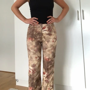 Byxor med print - Jag säljer mina utsvängda byxor med djungelprint som jag hittade på humana. Byxorna har använts en gång av mig och är i bra skick. Ner till finns det slitsar och snören som håller slitsarna samman😍🔥🔥 
