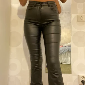 Skinnbyxor - Svarta lackade bootcut byxor från only. Högmidjade. Använt skick. Storlek M men skulle mer säga att de är S